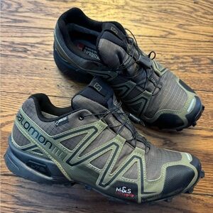 Salomon Speedcross trail running shoes. Specifically, the design with the "M&S"
